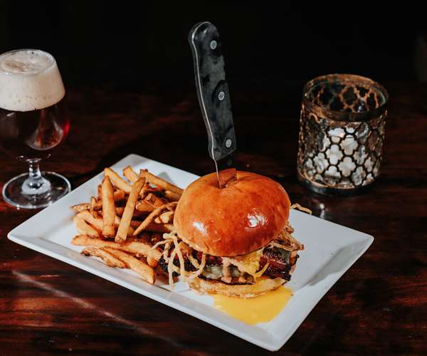 Pork Belly Burger with fried onions, local beef, braised pork belly, special sauce, local bun, fries